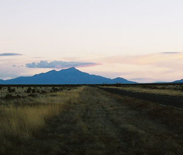 Photo of Big Hatchet Mountain in the distance with a road to it in the foreground.